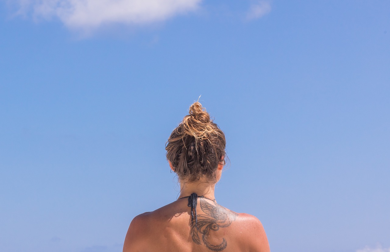 blone girl with a tattoo on her back